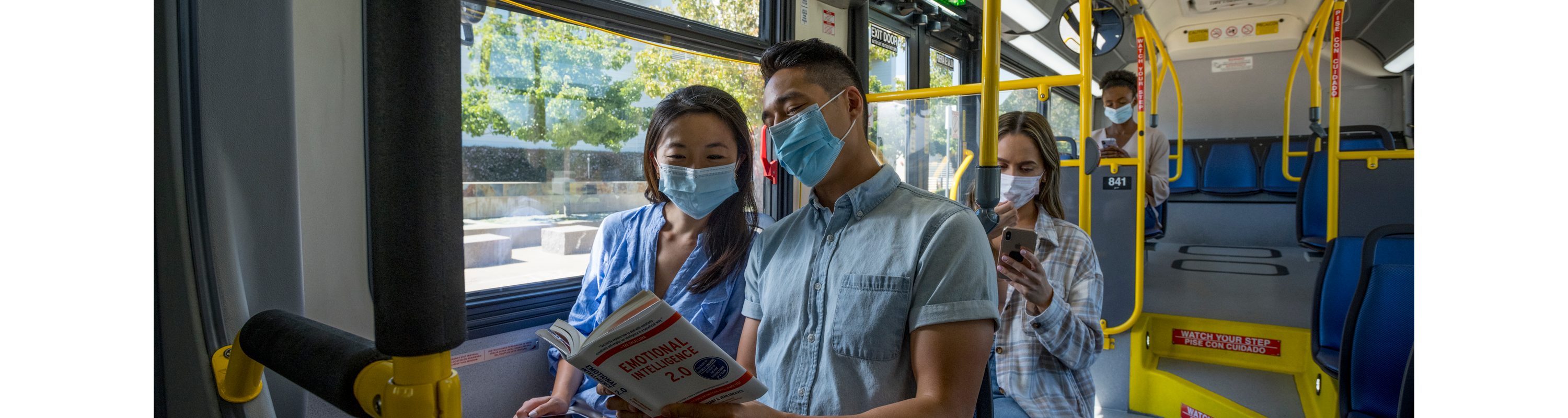 Students Reading Book on Bus