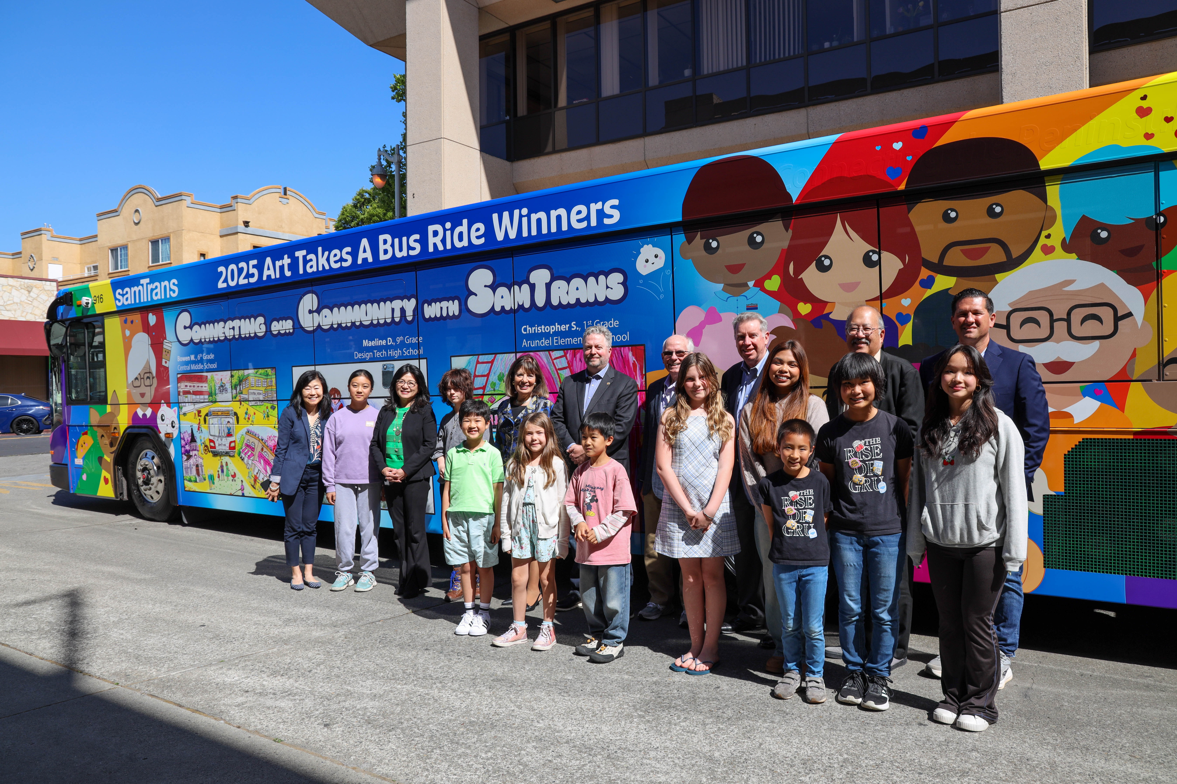 2025 Art Takes a bus rides winners pose in front of bus