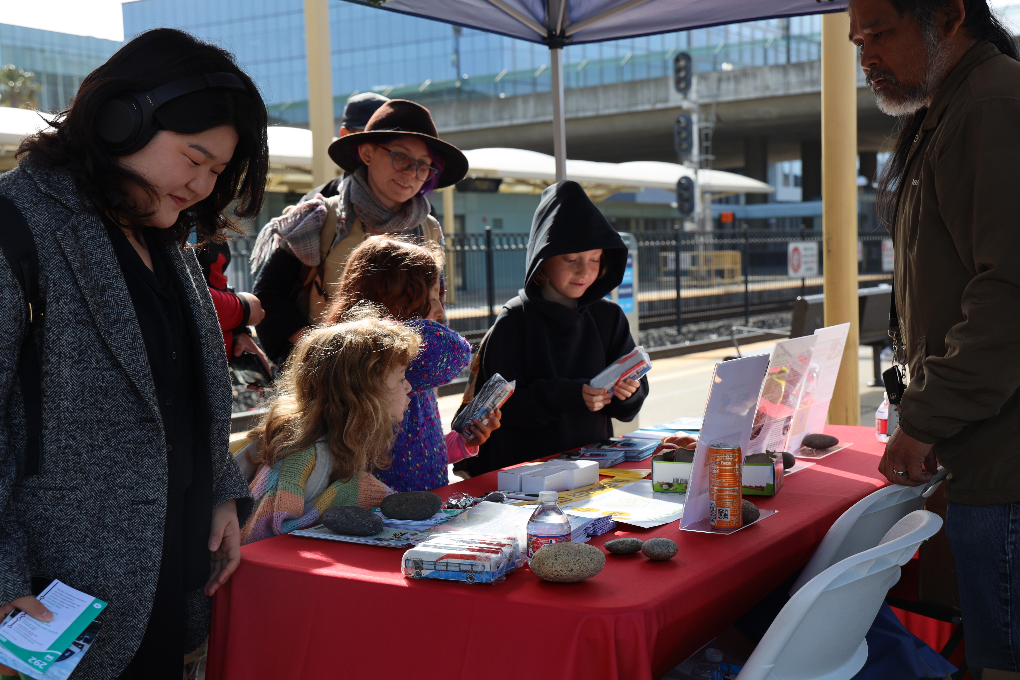 Group of people visiting table with swag and brochures
