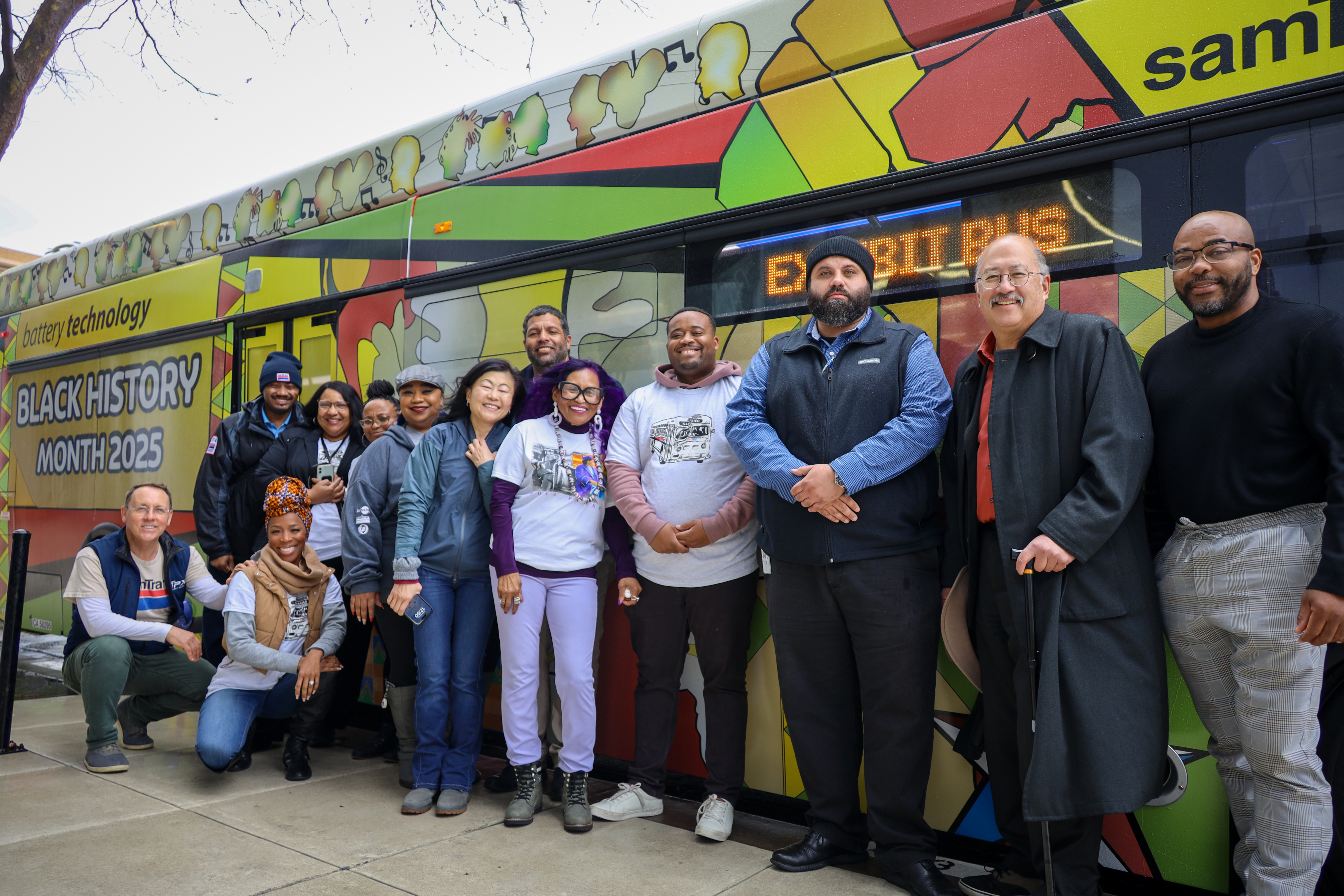 Group posing near SamTrans bus