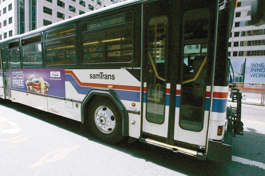 A SamTrans bus drives along El Camino Real