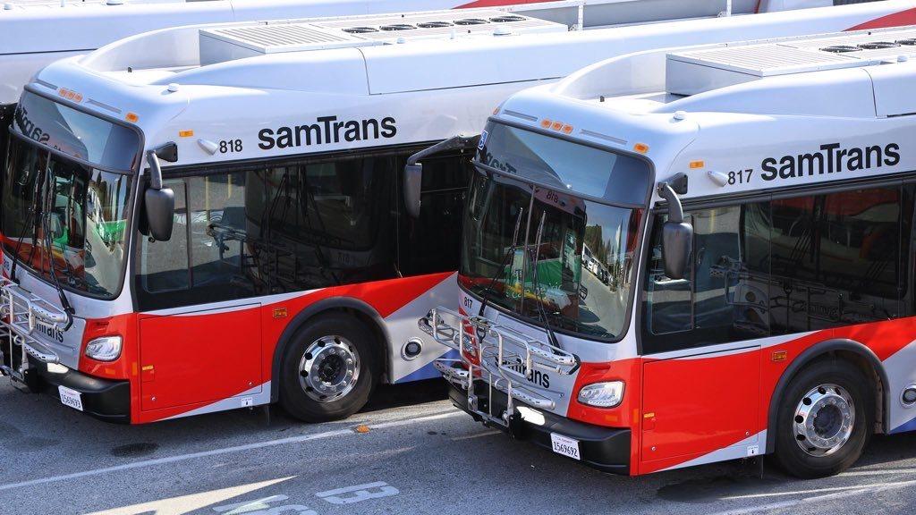 Two SamTrans buses parked side by side