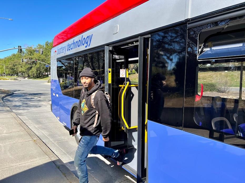 Passenger exiting new battery-powered electric bus in South San Francisco.