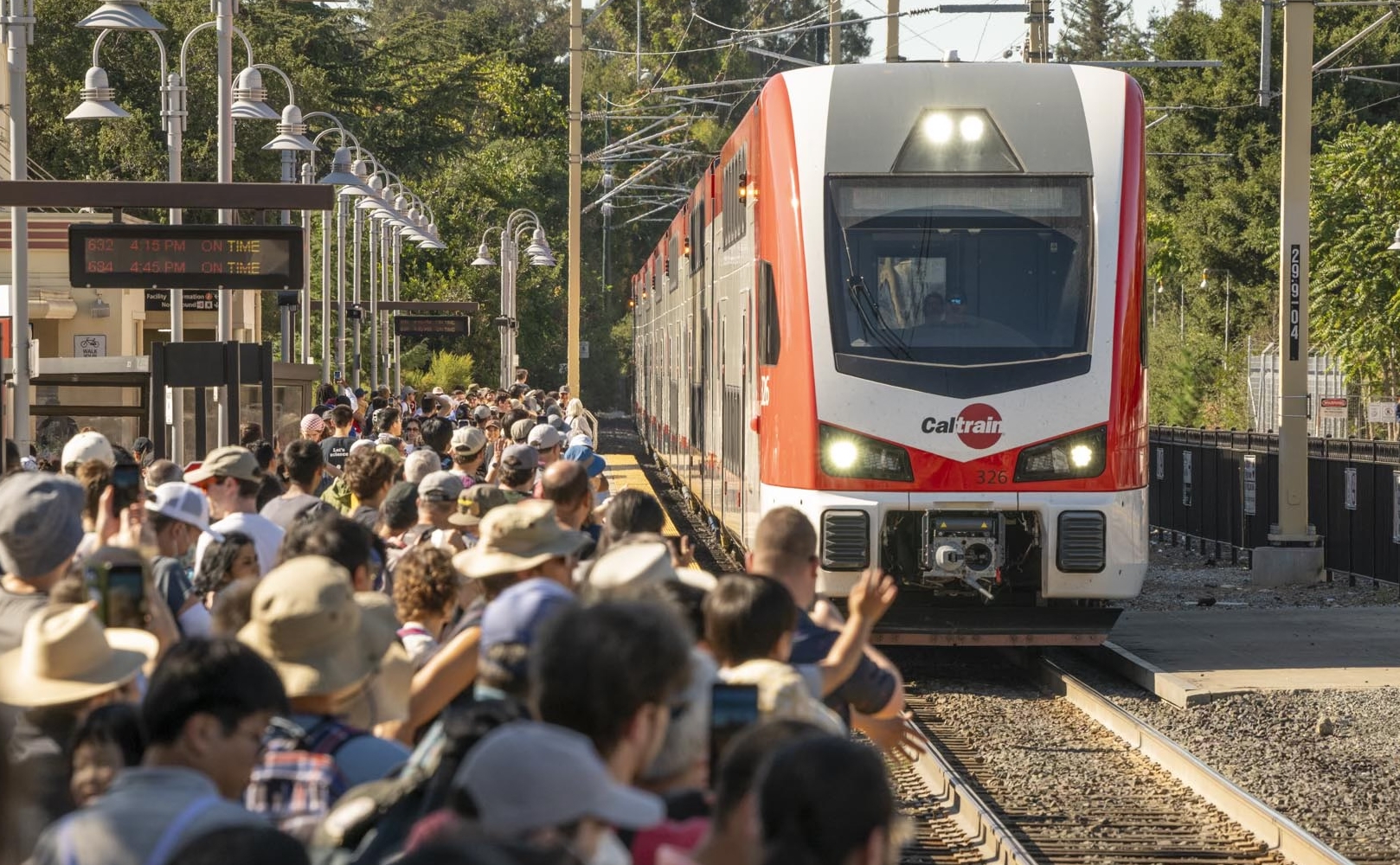 Crowd watches electric train arrive at Palo Alto Station