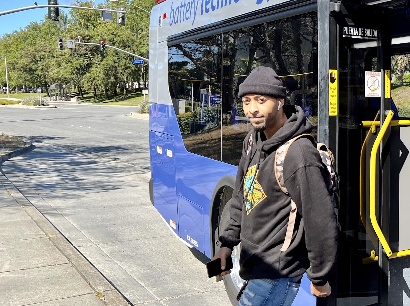 A passenger gets off a battery-electric bus (BEB) in South San Francisco (SSF)