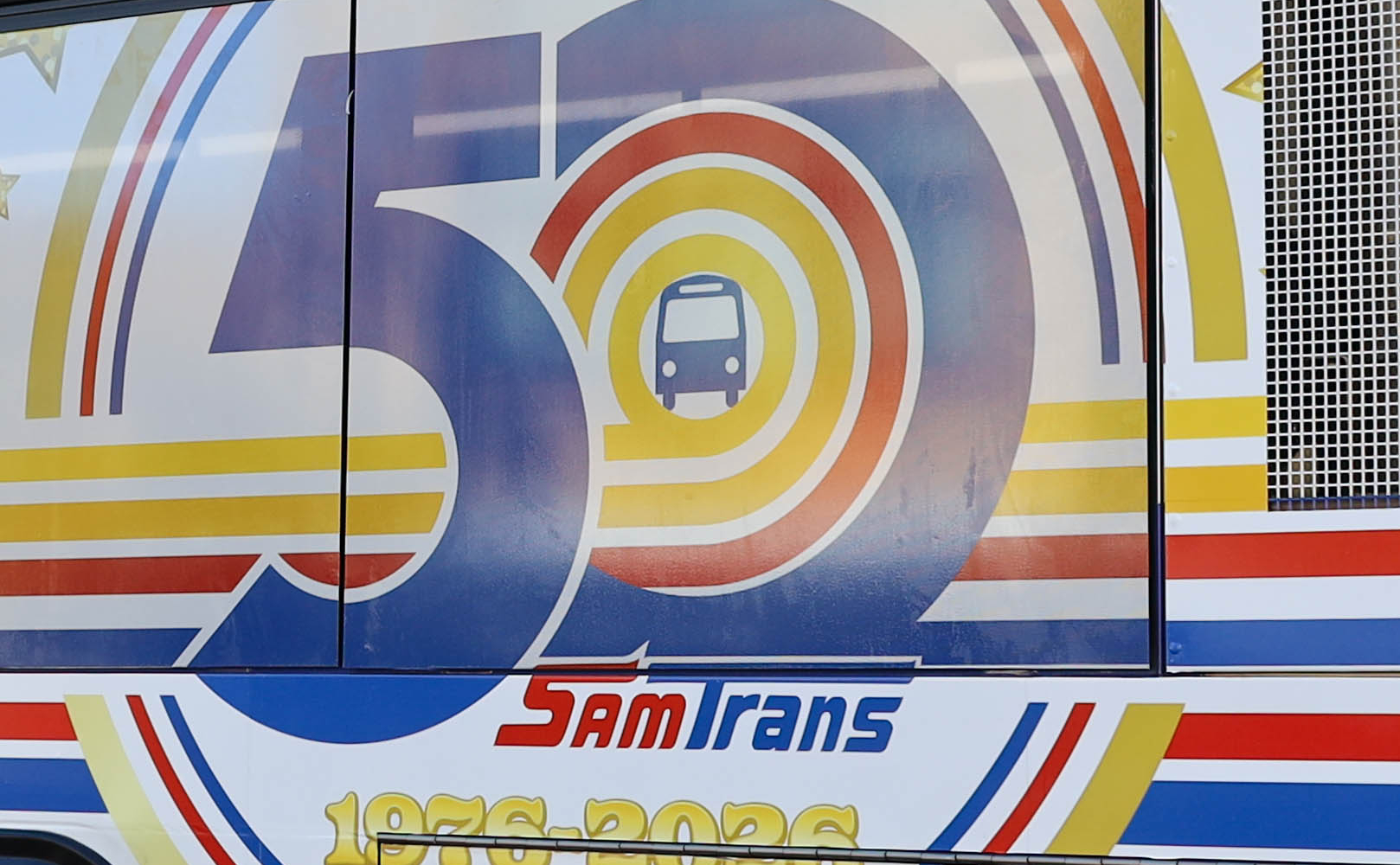 The first of two 50th Aniversary wrapped SamTrans buses is displayed in front of the agency's headquarters in San Carlos.