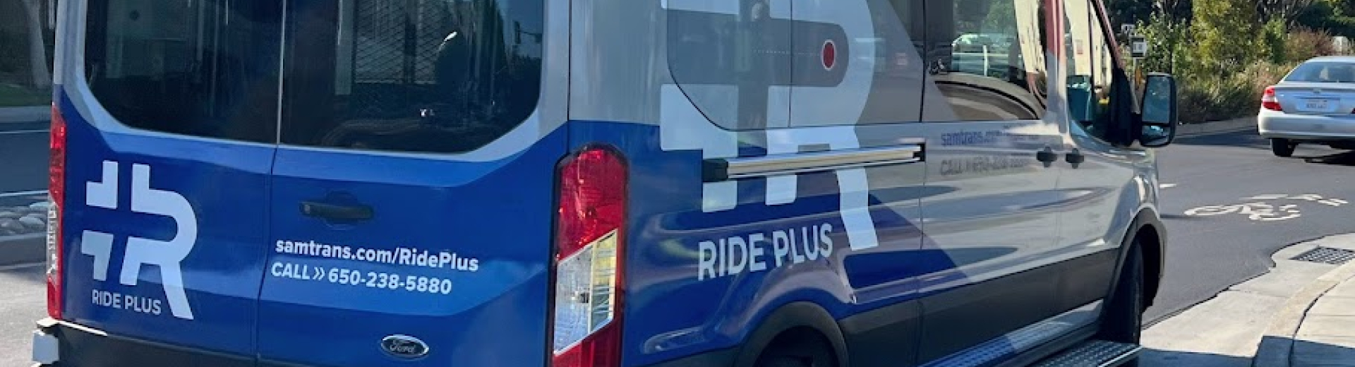 A Ride Plus van is parked along a street in East Palo Alto.