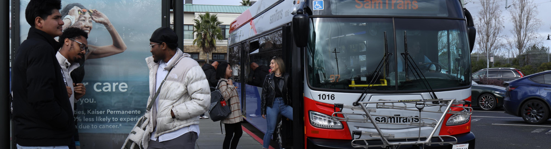 Group of people boarding SamTrans bus