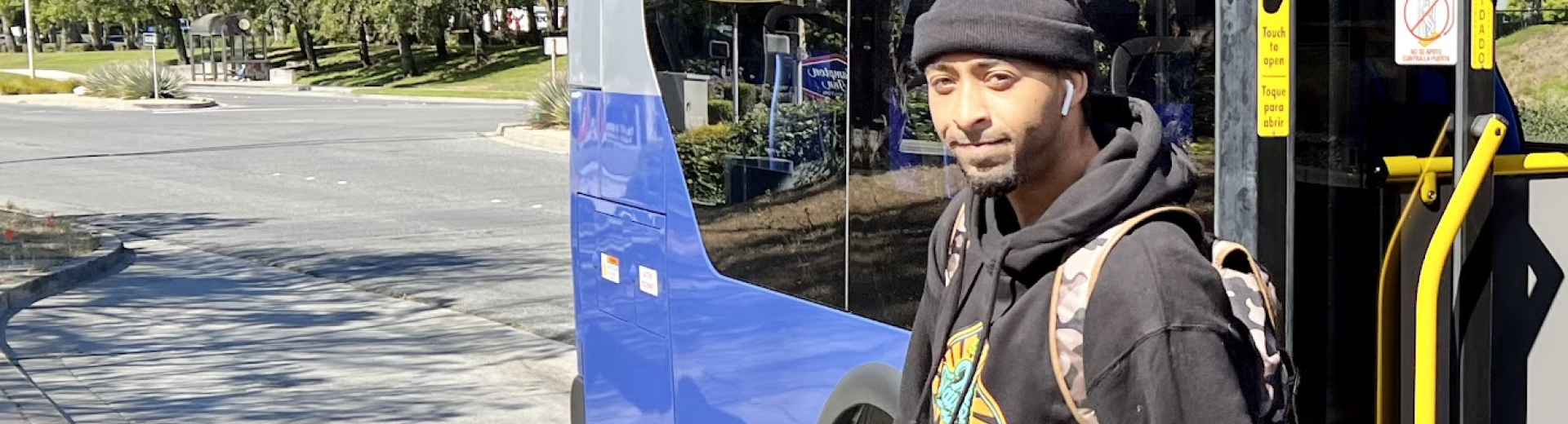 A passenger gets off a battery-electric bus (BEB) in South San Francisco (SSF)