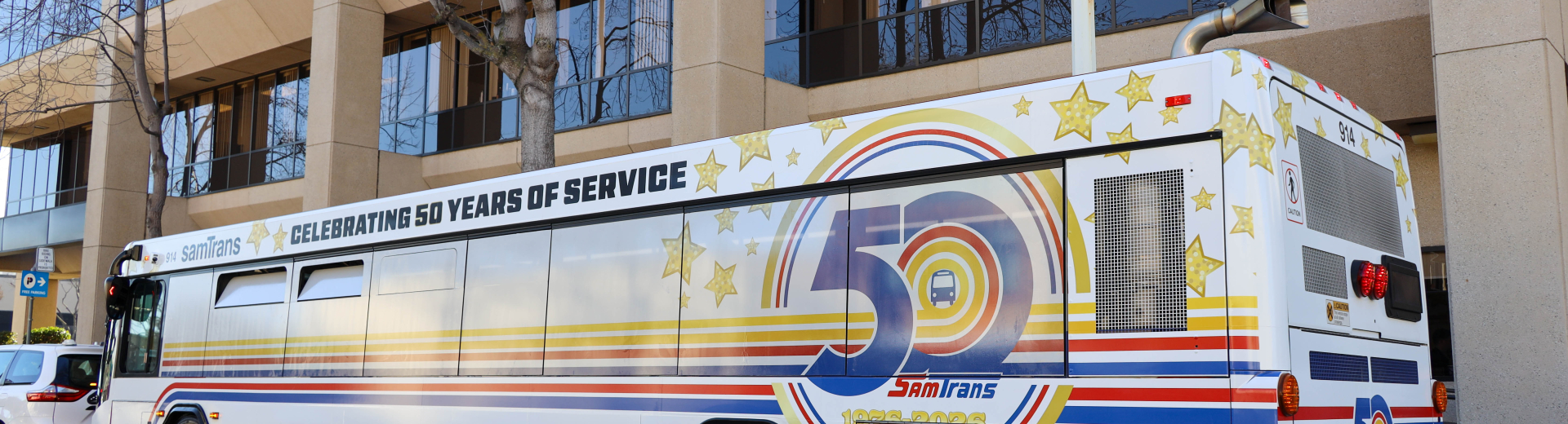 The first of two 50th Aniversary wrapped SamTrans buses is displayed in front of the agency's headquarters in San Carlos.
