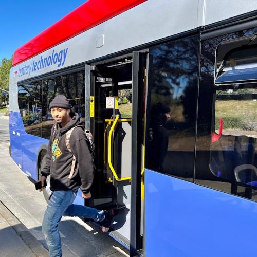 Passenger exiting new battery-powered electric bus in South San Francisco.