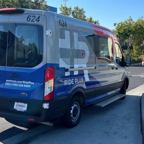 A Ride Plus van is parked along a street in East Palo Alto.