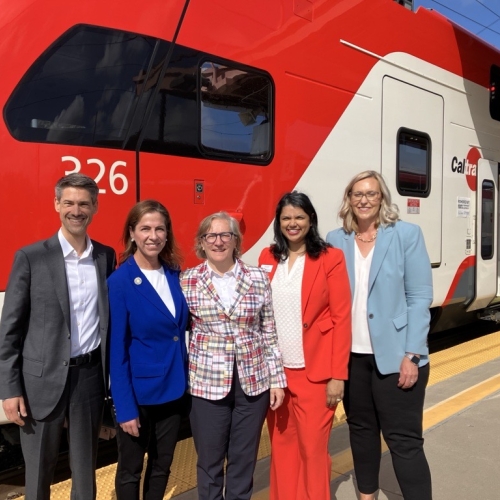 Michelle Bouchard and others in front of electric Caltrain