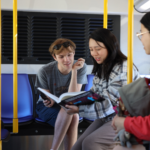 Three passengers sitting in the back of SamTrans bus