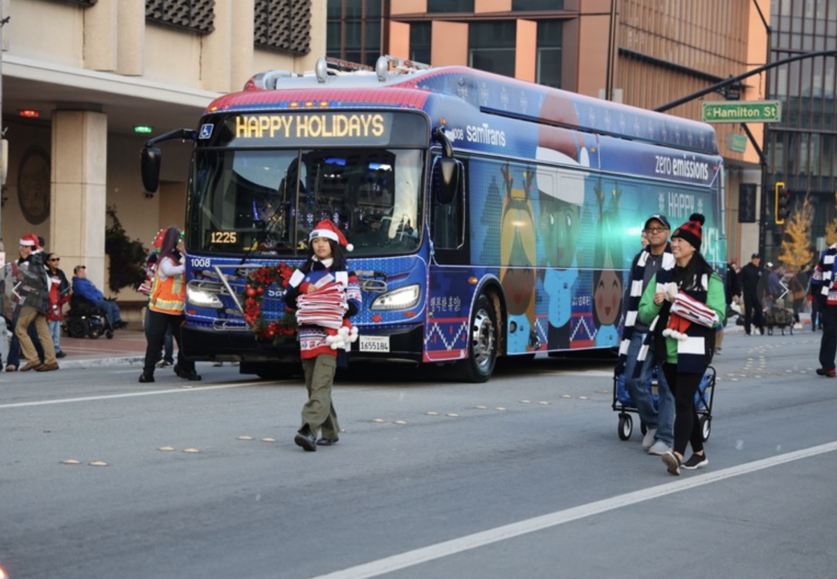 The SamTrans Holiday Bus makes its way through downtown Redwood City for the annual Hometown Holidays parade.